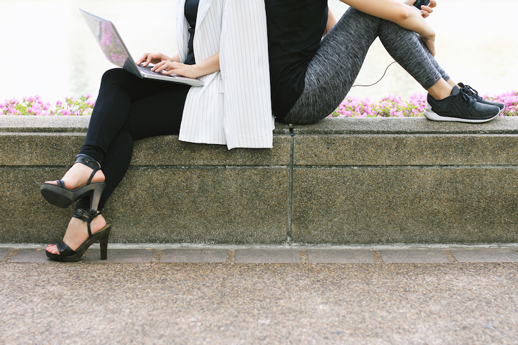 woman wearing heels on the left and woman wearing running shoes on the right 